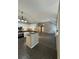 Open kitchen with stainless steel appliances and a breakfast bar, seamlessly flowing into living area at 12 Barrington Ct, Sharpsburg, GA 30277