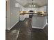 Modern kitchen featuring white cabinets, dark granite countertops and stainless steel appliances at 12 Barrington Ct, Sharpsburg, GA 30277