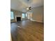 Cozy living room featuring a fireplace, ceiling fan and gleaming hardwood floors at 12 Barrington Ct, Sharpsburg, GA 30277