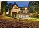 Exterior view of the house with a deck, patio, and backyard surrounded by mature trees at 1595 Northcliff Trce, Roswell, GA 30076