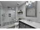 Bathroom featuring glass enclosed shower, tile flooring, and single sink vanity with granite countertops at 1595 Northcliff Trce, Roswell, GA 30076
