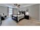 Comfortable bedroom with dark wood furnishings, soft carpeting, ceiling fan, and ample natural light at 1595 Northcliff Trce, Roswell, GA 30076