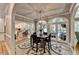 Dining area with stylish table, chairs, and views of the kitchen and sunroom at 1595 Northcliff Trce, Roswell, GA 30076