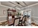 Open dining room with view into sun room and elegant lighting fixture at 1595 Northcliff Trce, Roswell, GA 30076