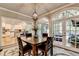 Dining area with stylish table, chairs, and views of the kitchen and sunroom at 1595 Northcliff Trce, Roswell, GA 30076