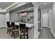 Kitchen with bar seating, stainless steel appliances, gray cabinets, and decorative backsplash at 1595 Northcliff Trce, Roswell, GA 30076