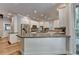 Modern kitchen with a large island, stainless steel appliances, hardwood floors, and bright lighting at 1595 Northcliff Trce, Roswell, GA 30076