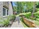 Beautiful landscaping with a stone pathway and retaining wall, enhancing the home's curb appeal at 1595 Northcliff Trce, Roswell, GA 30076