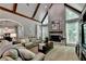Spacious living room with a brick fireplace, vaulted ceiling, and large windows for natural light at 1595 Northcliff Trce, Roswell, GA 30076