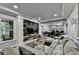 Open concept living room featuring a large sofa, wood accent wall and adjacent dinette at 1595 Northcliff Trce, Roswell, GA 30076