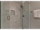 Tiled walk-in shower with clear glass door features updated shower head and built-in tiled niche at 1595 Northcliff Trce, Roswell, GA 30076