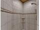 Tiled walk-in shower features neutral tones and convenient corner shelves at 1595 Northcliff Trce, Roswell, GA 30076