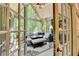 Relaxing sunroom with comfortable seating, vaulted ceiling, and a ceiling fan at 1595 Northcliff Trce, Roswell, GA 30076