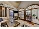 Inviting sunroom features brick floors, comfortable seating, and light-filled arched French doors to the exterior and interior at 1595 Northcliff Trce, Roswell, GA 30076