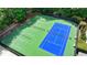 Aerial view of the community tennis courts with green and blue playing surfaces. Benches line the courts at 1595 Northcliff Trce, Roswell, GA 30076