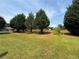 Large backyard featuring well-kept lawn and various trees at 425 Bell Flower Trl, Locust Grove, GA 30248
