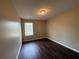 Modest bedroom with wood-look vinyl flooring and a window letting in natural light at 425 Bell Flower Trl, Locust Grove, GA 30248