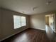 Modest bedroom with wood-look vinyl flooring and a window letting in natural light at 425 Bell Flower Trl, Locust Grove, GA 30248