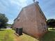 Two-story brick home with well-maintained lawn and modern HVAC system at 425 Bell Flower Trl, Locust Grove, GA 30248