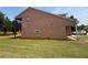 Brick home featuring a screened-in porch and covered patio area at 425 Bell Flower Trl, Locust Grove, GA 30248