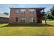 Brick exterior with a screened porch and balcony overlooking the backyard at 425 Bell Flower Trl, Locust Grove, GA 30248