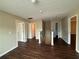 Upstairs hallway area with doors to multiple rooms, a set of stairs, and wood-look vinyl flooring at 425 Bell Flower Trl, Locust Grove, GA 30248