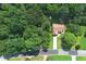 Aerial view of home surrounded by trees, featuring a long driveway at 106 Kimbell Farm Dr, Locust Grove, GA 30248