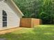 A side view of the home's fenced backyard with grass and mature trees at 106 Kimbell Farm Dr, Locust Grove, GA 30248