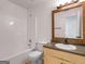 A clean bathroom with a tub and shower combo, a toilet, and a light wood vanity at 106 Kimbell Farm Dr, Locust Grove, GA 30248
