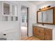 Bathroom with built-in storage and vanity with view into adjacent room at 106 Kimbell Farm Dr, Locust Grove, GA 30248