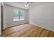 Bedroom with wood-look floors, wainscotting, and large window at 106 Kimbell Farm Dr, Locust Grove, GA 30248