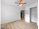 Bedroom features ceiling fan, light-colored hardwood floors, and standard closet with shelves for efficient storage at 106 Kimbell Farm Dr, Locust Grove, GA 30248