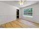 Bright bedroom features hardwood floors, white walls, and a large window offering plenty of natural light at 106 Kimbell Farm Dr, Locust Grove, GA 30248