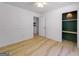 Bedroom with wood-look floors, closet with accent lighting, and wainscotting at 106 Kimbell Farm Dr, Locust Grove, GA 30248
