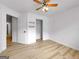 Simple bedroom design with light-colored hardwood floors, ceiling fan, and accessible closet space at 106 Kimbell Farm Dr, Locust Grove, GA 30248