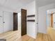 Hallway with wood-look floors, and dark wood barn doors leading to closet space at 106 Kimbell Farm Dr, Locust Grove, GA 30248