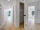 Hallway with wood-look floors, multiple doorways and neutral paint at 106 Kimbell Farm Dr, Locust Grove, GA 30248