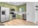 Updated kitchen with stainless appliances, farmhouse sink, and stylish light-green cabinetry at 106 Kimbell Farm Dr, Locust Grove, GA 30248