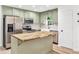 Charming kitchen with a butcher block island, stainless steel appliances and green cabinetry at 106 Kimbell Farm Dr, Locust Grove, GA 30248
