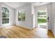 Bright, airy living room with hardwood floors and large windows providing natural light at 106 Kimbell Farm Dr, Locust Grove, GA 30248