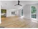 Open living space with hardwood floors, arched windows, and view of the modern kitchen at 106 Kimbell Farm Dr, Locust Grove, GA 30248