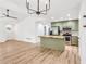 Open floor plan showcasing the living room and kitchen, complete with light-colored hardwood floors and modern lighting at 106 Kimbell Farm Dr, Locust Grove, GA 30248
