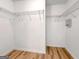 Spacious walk-in closet with wood-look floors and metal shelving to maximize storage space at 106 Kimbell Farm Dr, Locust Grove, GA 30248