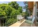 This unit features a private balcony with chairs, table, and tree top views at 1225 Church St # M, Decatur, GA 30030