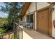 The balcony has seating, a sliding door, and a beautiful view of the forest at 1225 Church St # M, Decatur, GA 30030