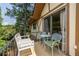 Relaxing balcony with seating provides a cozy outdoor living space with lush green tree views at 1225 Church St # M, Decatur, GA 30030