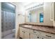 Bathroom features a shower, toilet, and vanity with a large mirror and natural lighting at 1225 Church St # M, Decatur, GA 30030