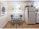 Cozy eat-in kitchen features a glass-top dining table and white appliances at 1225 Church St # M, Decatur, GA 30030