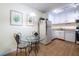 Bright eat-in kitchen with a glass-top table and modern light fixture at 1225 Church St # M, Decatur, GA 30030