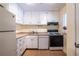 Functional kitchen featuring white cabinets, modern appliances, and laminate countertops at 1225 Church St # M, Decatur, GA 30030